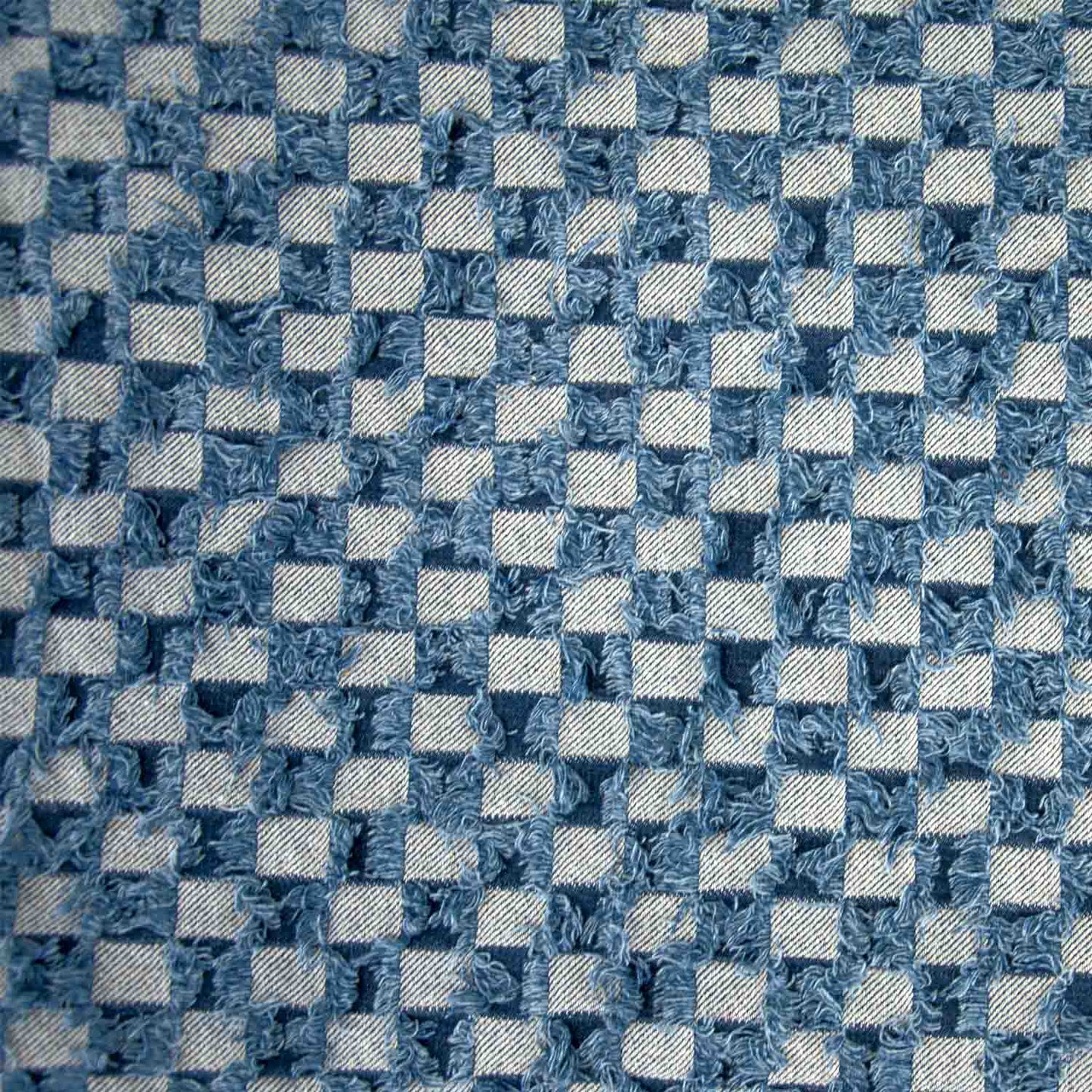 Spijkerstof met blokjes print.