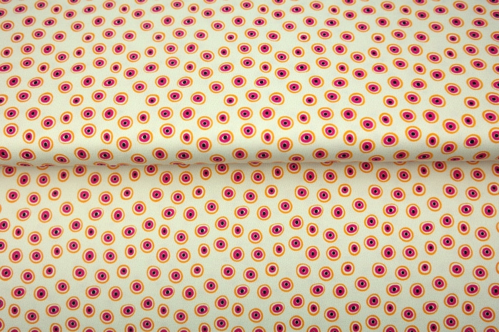 Creme kleurige digitale print jersey met oranje roze rondjes, oogjes.