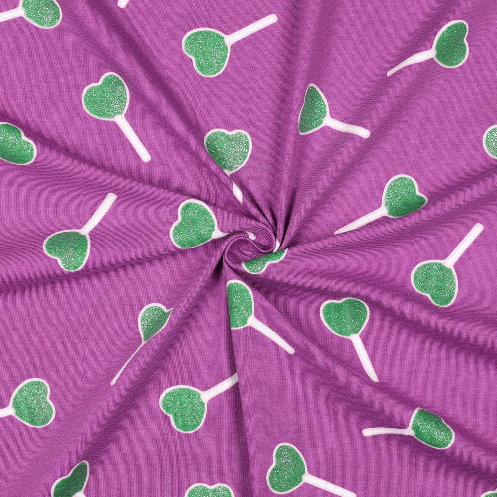 Paarse tricot met groene glitter lollies erop.