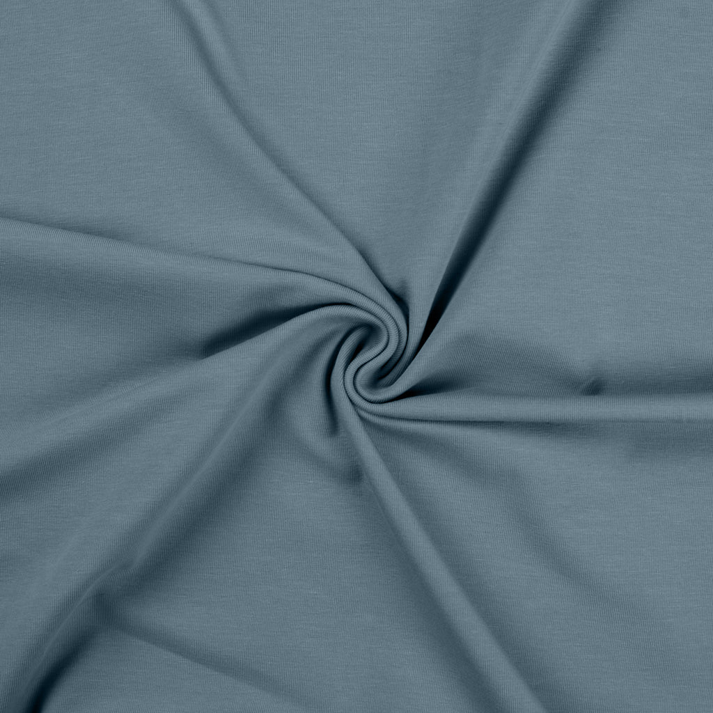 Dusty blauwe uni katoenen tricot stof.