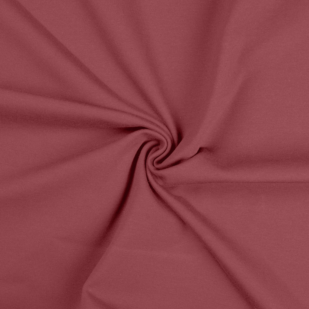 Oud roze uni katoenen tricot stof.