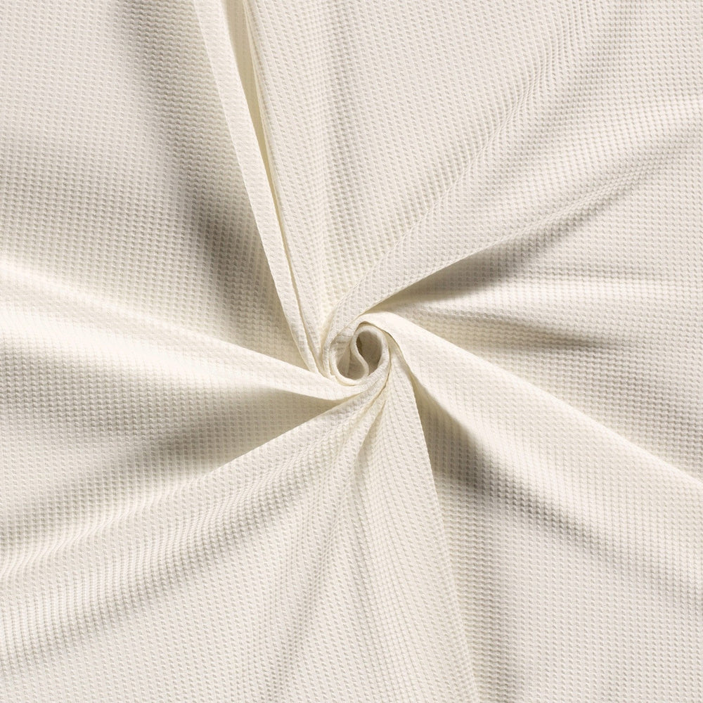 Gebreide wafelstof met stretch in de kleur offwhite.