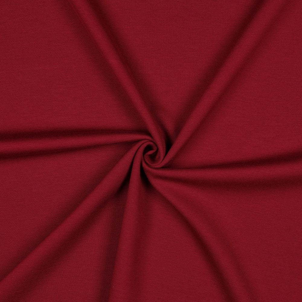 Bordeaux rode uni punta royal, een dikkere soort tricot die ideaal is voor damesbroeken of jurken.