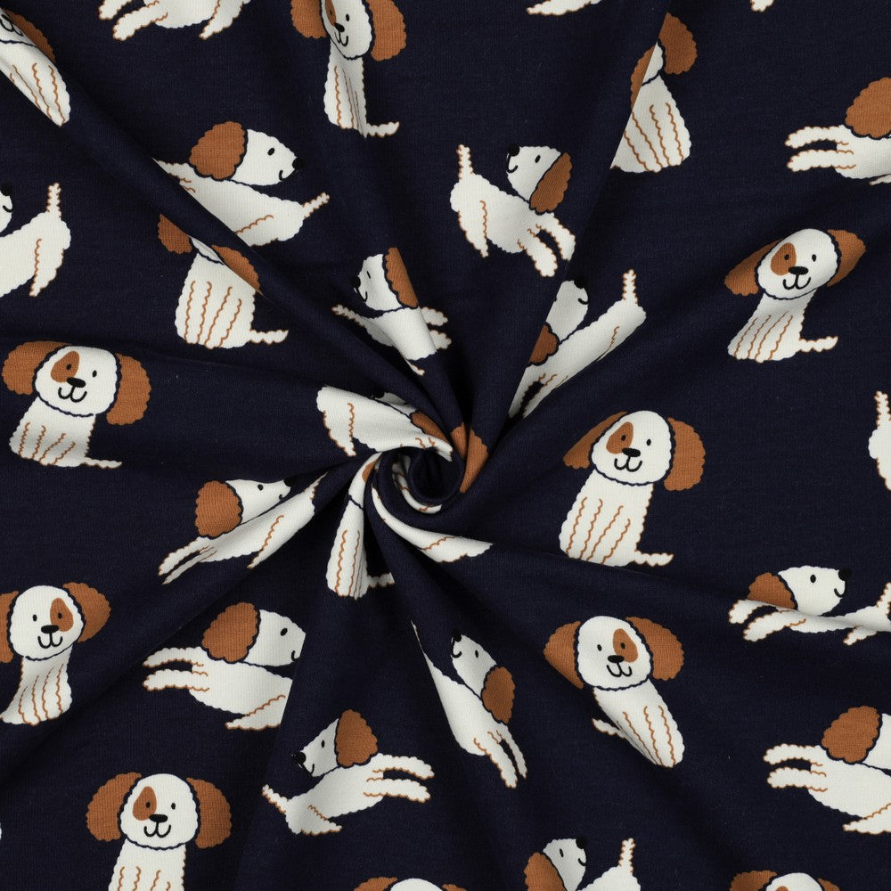 Zachte sweaterstof in de kleur navy blauw met wit bruine hondjes.
