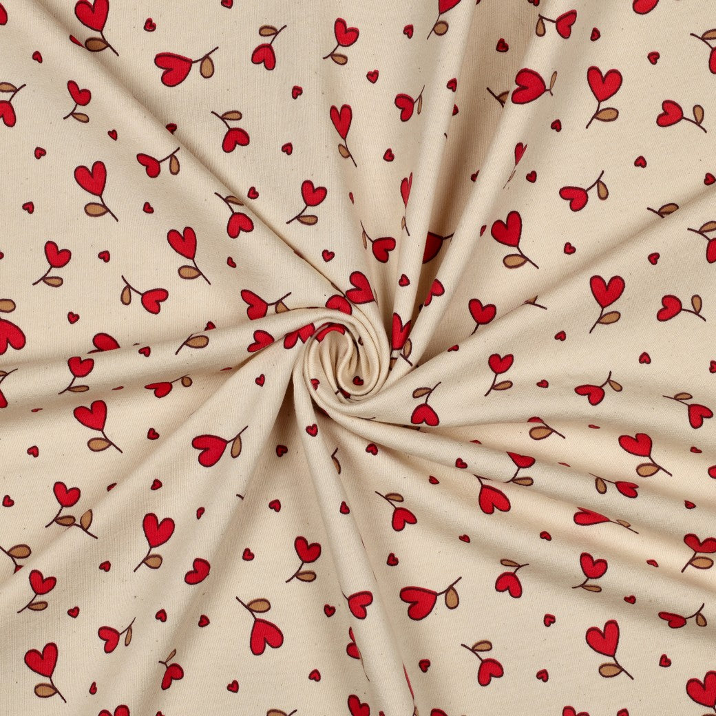 Sweatstof in natural met fuchsia hartjes