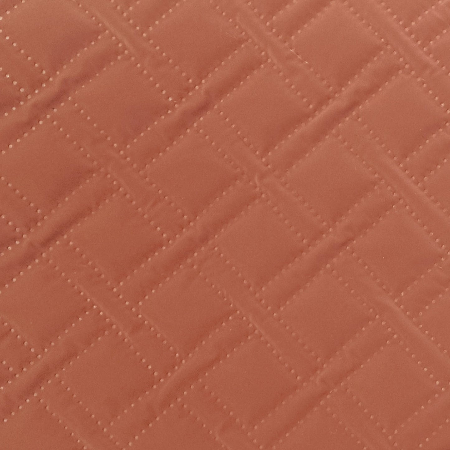 Gewatteerde techno peachskin stof in roest kleur.