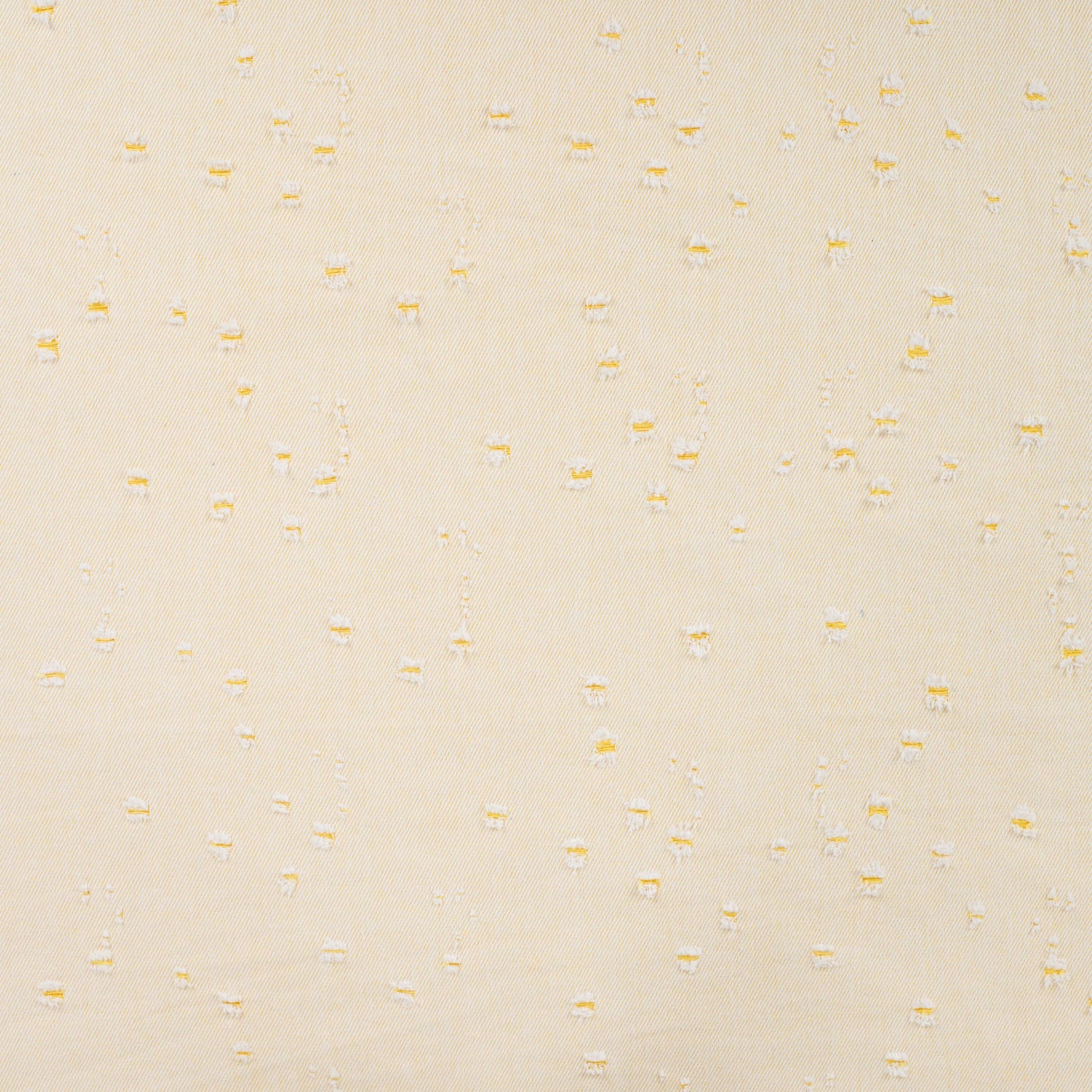 Denim stof pastelgeel met kleine gaatjes.