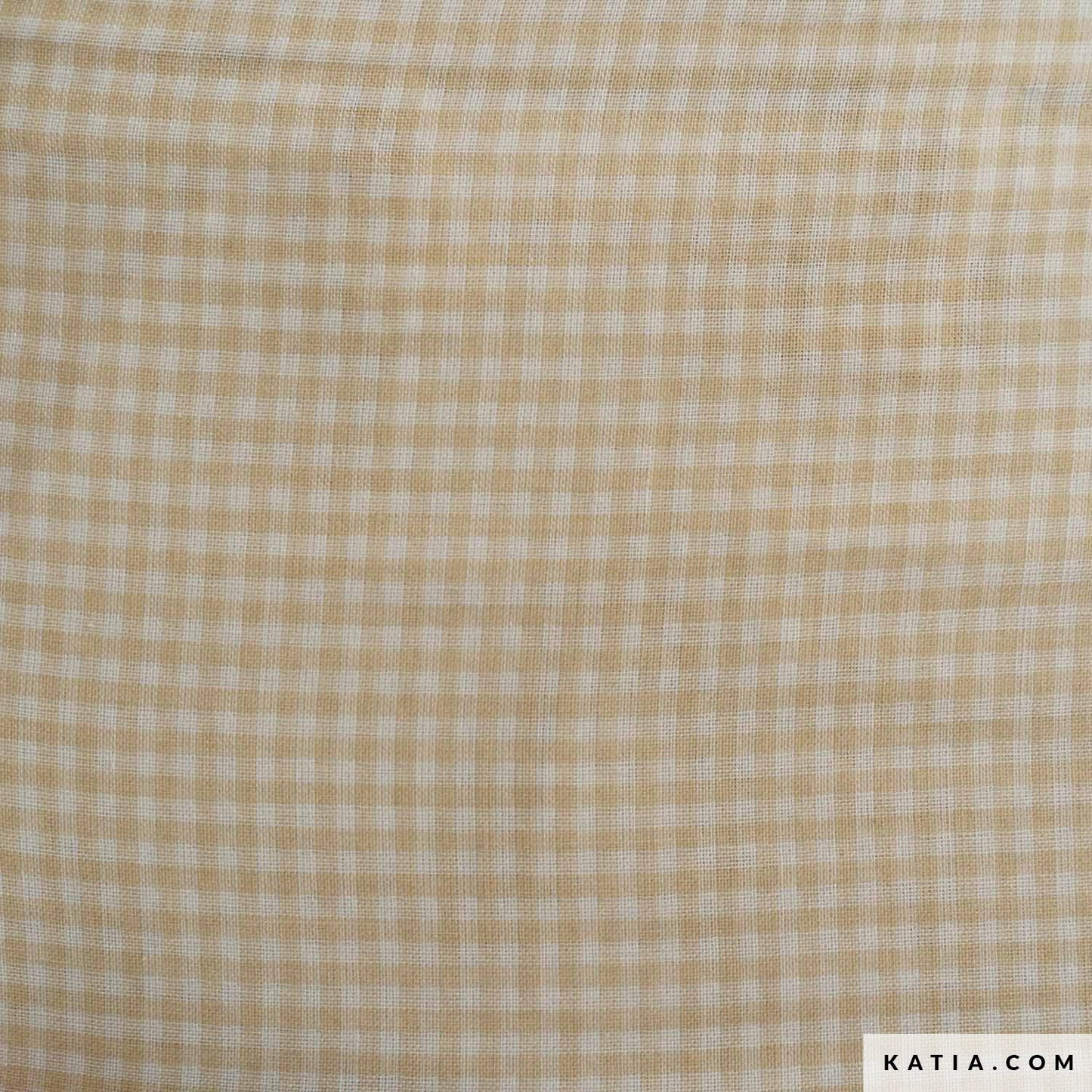 Biologische katoenen hydrofiele stof in ecru met licht bruine blokjes.