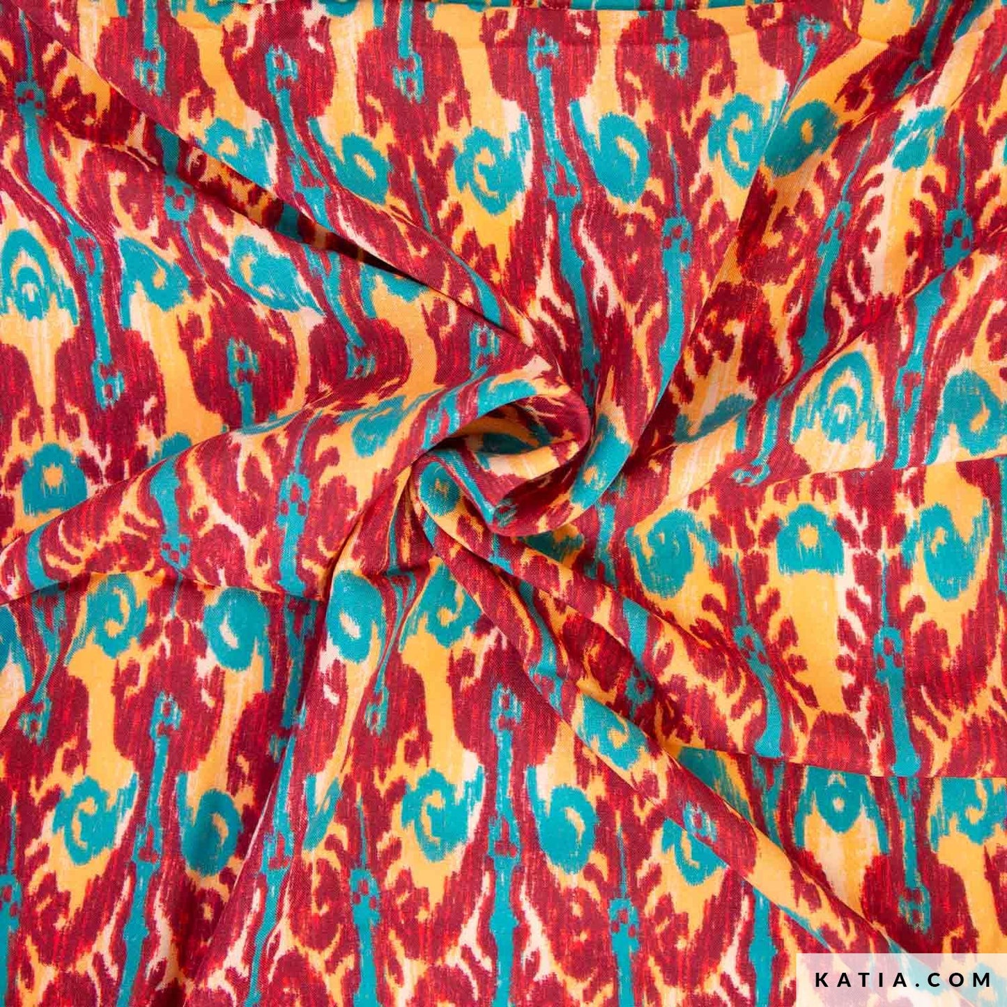 Viscose stof met rood, oranje en turquoise print voor bijvoorbeeld een jurk, rok, blouse over zomerse broek. 
